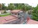 Aerial view showcases the red-tiled roof, screened pool area, and unique architecture of this house at 4420 Conway Gardens Rd, Orlando, FL 32806