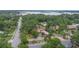 High aerial view of a home nestled in a lush, tree-filled neighborhood with a glimpse of the lake at 4420 Conway Gardens Rd, Orlando, FL 32806