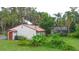 Spacious backyard with an enclosed patio, lush greenery, and mature trees providing privacy at 4420 Conway Gardens Rd, Orlando, FL 32806