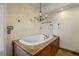 Bright bathroom features a tub with wood paneled base and decorative lighting at 4420 Conway Gardens Rd, Orlando, FL 32806
