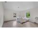 Bedroom with gray wood floors features three large windows and natural lighting at 4420 Conway Gardens Rd, Orlando, FL 32806