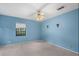 Serene bedroom with blue walls, carpeted floors, neutral window blinds, and decorative sconces at 4420 Conway Gardens Rd, Orlando, FL 32806