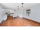 The dining room has tile floors and modern lighting fixtures and is connected to the kitchen at 4420 Conway Gardens Rd, Orlando, FL 32806