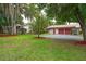 An exterior shot of the front yard with the home and detached garage at 4420 Conway Gardens Rd, Orlando, FL 32806