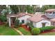 Quaint home with red tile roof, charming front entrance, and well-manicured landscaping at 4420 Conway Gardens Rd, Orlando, FL 32806