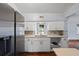 Bright kitchen has white cabinets, stainless steel appliances, and a view of the screened in back porch at 4420 Conway Gardens Rd, Orlando, FL 32806