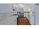 Kitchen featuring stainless steel appliances, white cabinets, and white countertops at 4420 Conway Gardens Rd, Orlando, FL 32806