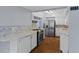 The kitchen features white cabinets, stainless steel appliances, and quartz countertops at 4420 Conway Gardens Rd, Orlando, FL 32806