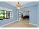 Dining room with a chandelier and a view into the adjacent living room at 4420 Conway Gardens Rd, Orlando, FL 32806