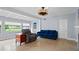 Bright living room features neutral walls, tile floors, and large windows offering an abundance of natural light at 4420 Conway Gardens Rd, Orlando, FL 32806