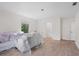 Living room features light wood floors, new furniture covered in plastic, and bright lighting at 4420 Conway Gardens Rd, Orlando, FL 32806