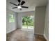 Bedroom with neutral walls, tile floors and a large sliding glass door leading to the outside at 470 Sunset Rd, Deltona, FL 32725