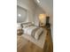 Bright bedroom featuring a cozy chair in a corner, a large mirror, and a neutral color palette at 470 Sunset Rd, Deltona, FL 32725