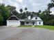A daytime shot of the home's exterior, with green grass in the front at 470 Sunset Rd, Deltona, FL 32725