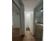 Hallway with light wood floors leading to rooms with white walls and a skylight at 470 Sunset Rd, Deltona, FL 32725