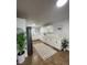 Bright kitchen featuring white cabinets, quartz countertops, and stainless steel appliances at 470 Sunset Rd, Deltona, FL 32725