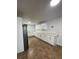 Bright kitchen features white cabinets, granite countertops, tile backsplash, and stainless steel appliances at 470 Sunset Rd, Deltona, FL 32725
