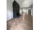 Open living room with stone fireplace, tile flooring, and kitchen at 470 Sunset Rd, Deltona, FL 32725