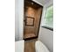Shower with neutral colored tile and dark accents, plus a window letting in natural light at 470 Sunset Rd, Deltona, FL 32725