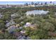 Stunning aerial view showcasing the neighborhood, nearby lake, and the city skyline in the backdrop at 522 Cherokee Dr, Orlando, FL 32801