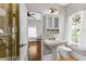 Bright bathroom with pedestal sink, storage cabinet and walk-in shower at 522 Cherokee Dr, Orlando, FL 32801