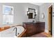 Bathroom featuring a tub, modern vanity with dark countertop, and stylish light fixtures at 522 Cherokee Dr, Orlando, FL 32801