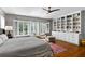 Bright bedroom featuring custom built-in bookcase, hardwood floors, and shuttered windows at 522 Cherokee Dr, Orlando, FL 32801