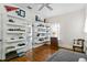 Bright bedroom featuring floating shelves and hardwood floors, with ensuite bath at 522 Cherokee Dr, Orlando, FL 32801