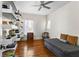 Cozy bedroom features hardwood floors, recessed shelving and a ceiling fan at 522 Cherokee Dr, Orlando, FL 32801