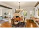 Elegant dining room with hardwood floors, a stone fireplace, and an ornate chandelier, perfect for entertaining at 522 Cherokee Dr, Orlando, FL 32801