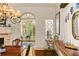 Elegant dining room featuring a decorative chandelier, fireplace, and an arched doorway with views of the garden at 522 Cherokee Dr, Orlando, FL 32801