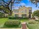 Stunning two-story home featuring lush landscaping, a brick pathway, and distinctive architectural details at 522 Cherokee Dr, Orlando, FL 32801