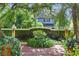 Charming home featuring a brick-paved courtyard and lush landscaping, creating a serene and inviting entrance at 522 Cherokee Dr, Orlando, FL 32801