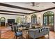 Open-concept dining and living area with high ceilings, wood beams, and arched windows at 522 Cherokee Dr, Orlando, FL 32801
