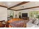 Bright living room featuring terracotta floors, coffered ceilings, arched windows, and a comfortable grey sofa at 522 Cherokee Dr, Orlando, FL 32801