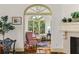 Comfortable seating area with hardwood floors, a fireplace, and views into the sunroom, offering relaxed living at 522 Cherokee Dr, Orlando, FL 32801