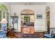 Spacious living room with terracotta floors, arched doorways, and comfortable seating with views of the outdoor scenery at 522 Cherokee Dr, Orlando, FL 32801