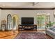Inviting living room featuring terracotta floors, coffered ceilings, arched windows, and a cozy seating arrangement at 522 Cherokee Dr, Orlando, FL 32801