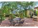 Covered patio with brick pavers, outdoor seating, and mature landscaping at 522 Cherokee Dr, Orlando, FL 32801