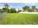 Expansive backyard with lush green grass, surrounded by fencing for added privacy at 663 Romano Ave, Orlando, FL 32807