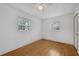 Bedroom with wood floors, two windows, and a ceiling fan at 663 Romano Ave, Orlando, FL 32807