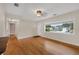Bright living room featuring gleaming hardwood floors and large window for natural light at 663 Romano Ave, Orlando, FL 32807