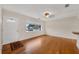 Bright living room featuring gleaming hardwood floors and large window for natural light at 663 Romano Ave, Orlando, FL 32807