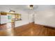 Living room with wood floors and an eat-in bar leading to the kitchen at 663 Romano Ave, Orlando, FL 32807