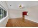 Bright living room featuring gleaming hardwood floors and large window for natural light at 663 Romano Ave, Orlando, FL 32807