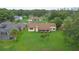 This aerial shot showcases the home's generous backyard, mature trees, and peaceful neighborhood setting at 6766 Edgeworth Dr, Orlando, FL 32819