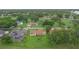 An aerial view of a home nestled among mature trees, highlighting its expansive backyard and neighborhood at 6766 Edgeworth Dr, Orlando, FL 32819