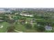 Aerial view of a home near a golf course and with the city skyline in the distance on a sunny day at 6766 Edgeworth Dr, Orlando, FL 32819