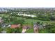 This aerial shot showcases a home close to a golf course, with a city skyline on the horizon at 6766 Edgeworth Dr, Orlando, FL 32819