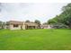 Expansive backyard featuring a lush green lawn and a charming covered patio, perfect for outdoor enjoyment at 6766 Edgeworth Dr, Orlando, FL 32819